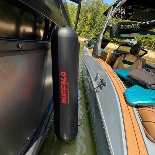 Buffalo Gear Black inflatable boat fender attached to a boat on a lake.