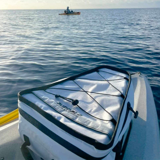 Buffalo Gear White Kayak Cooler Bag on a kayak in the water, with another person in a kayak in the background.
