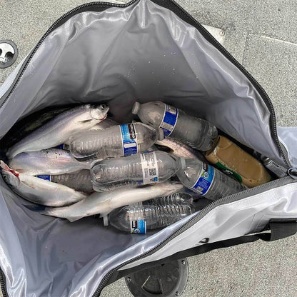 Buffalo Gear Fish Cooler Bag containing fish and frozen plastic bottles was placed on the concrete floor.