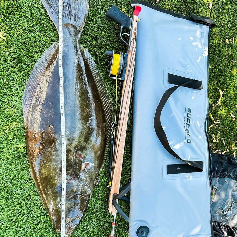 A Buffalo Gear Fish Cooler Bag with a freshly caught turbot placed next to it.