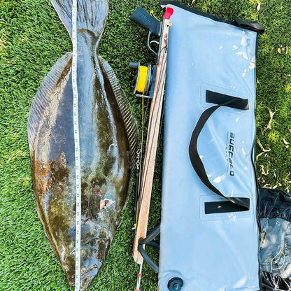 A Buffalo Gear Fish Cooler Bag with a freshly caught turbot placed next to it.