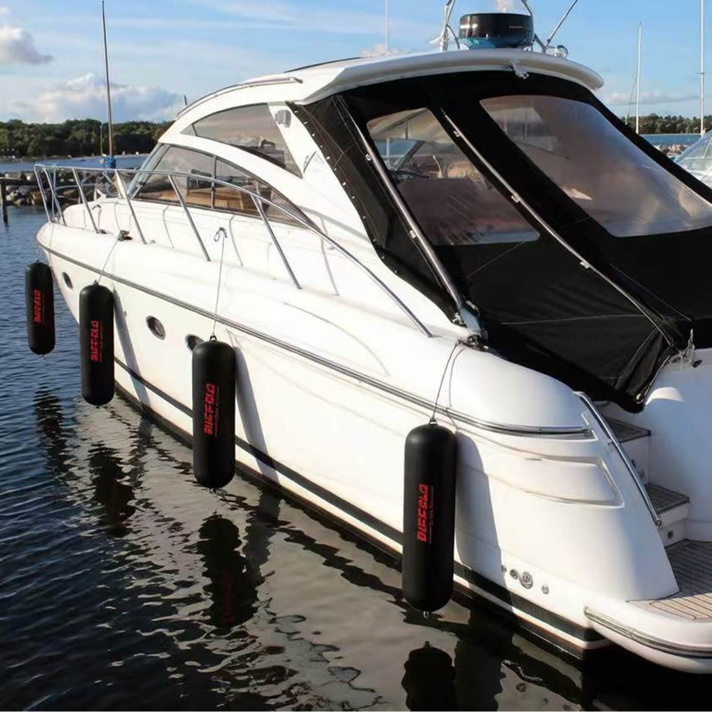 White yacht with Buffalo Gear boat fenders on a dock
