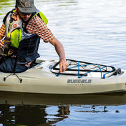 a man in a hat and vest paddling a kayak
