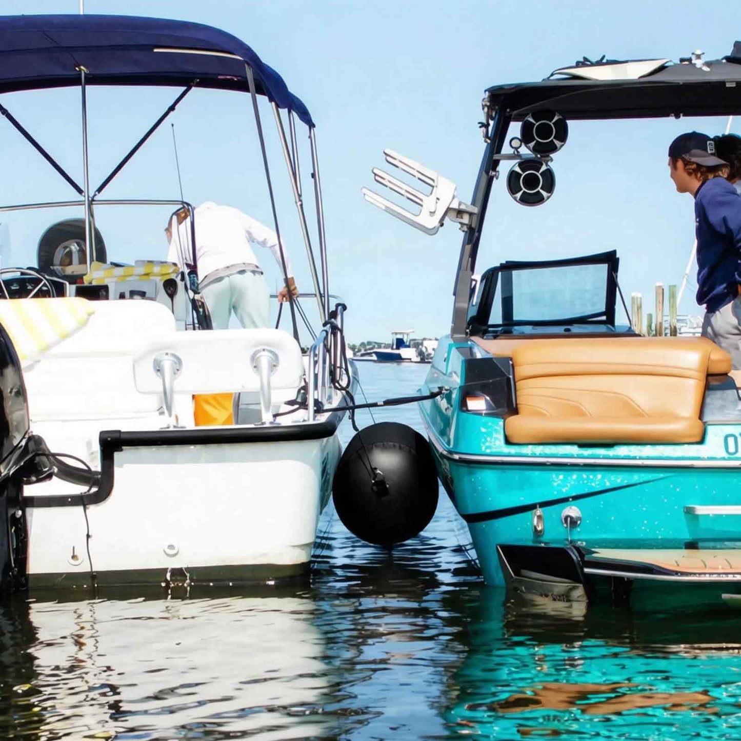 Two boats rafted together with a Buffalo Gear inflatable boat fender between them