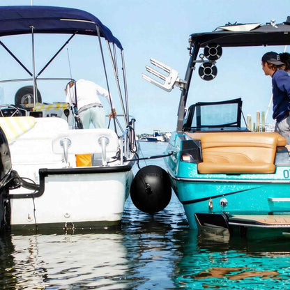 Two boats rafted together with a Buffalo Gear inflatable boat fender between them